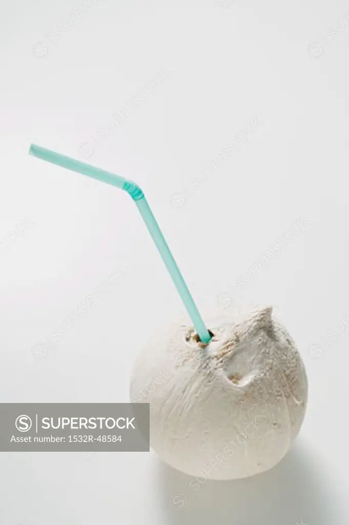 Shelled coconut with straw