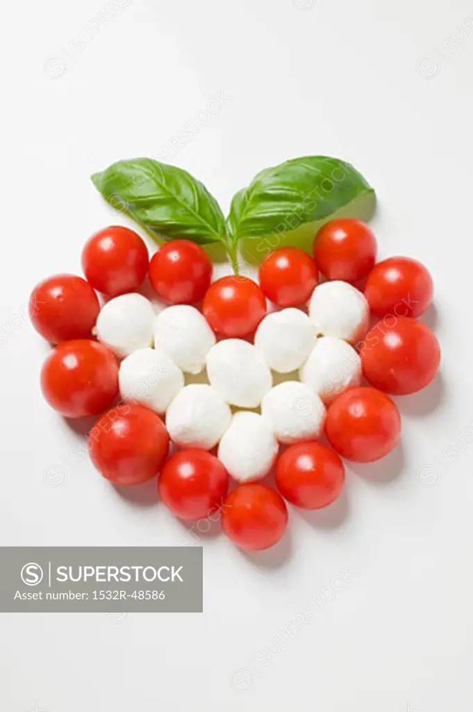 Tomato and mozzarella forming a heart with basil