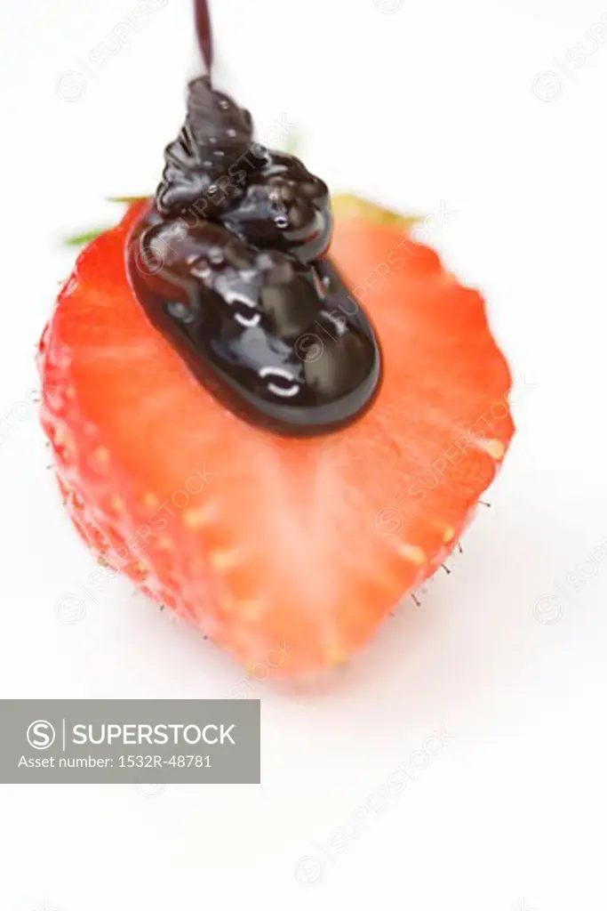 Half a strawberry with chocolate sauce