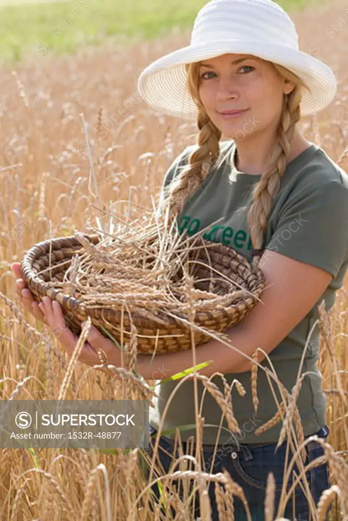 Woman with basket in a corn field