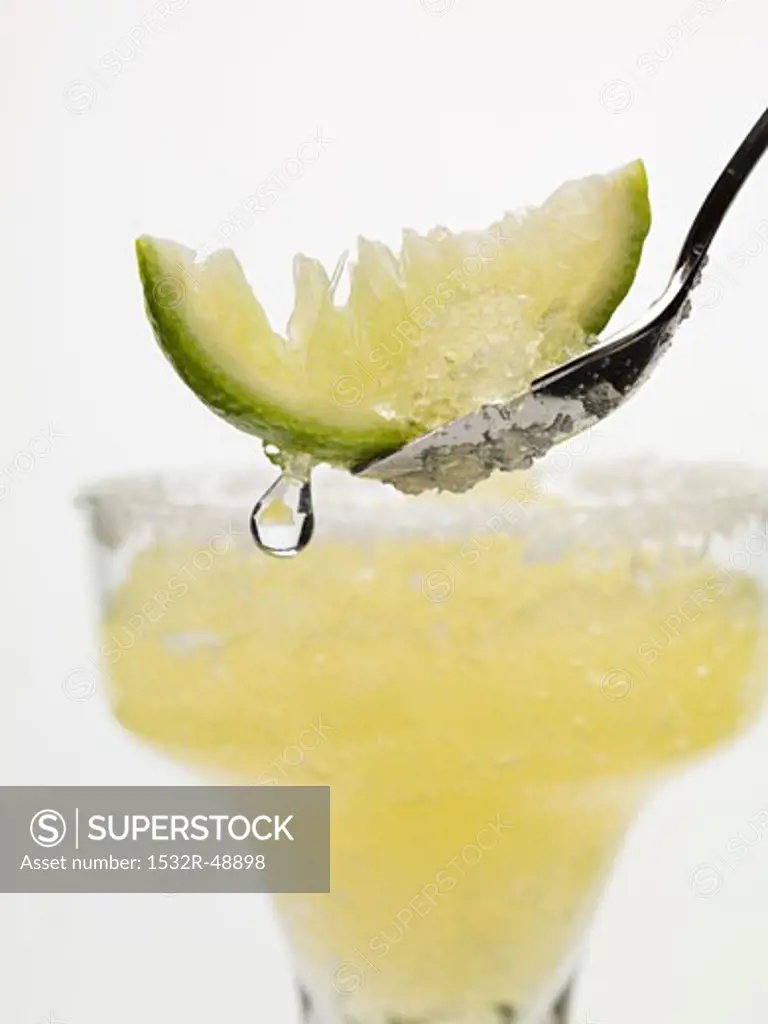 Frozen Margarita, lime wedge on spoon