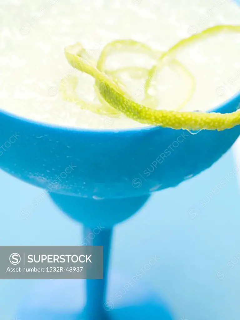 Frozen Margarita with lime zest in blue glass