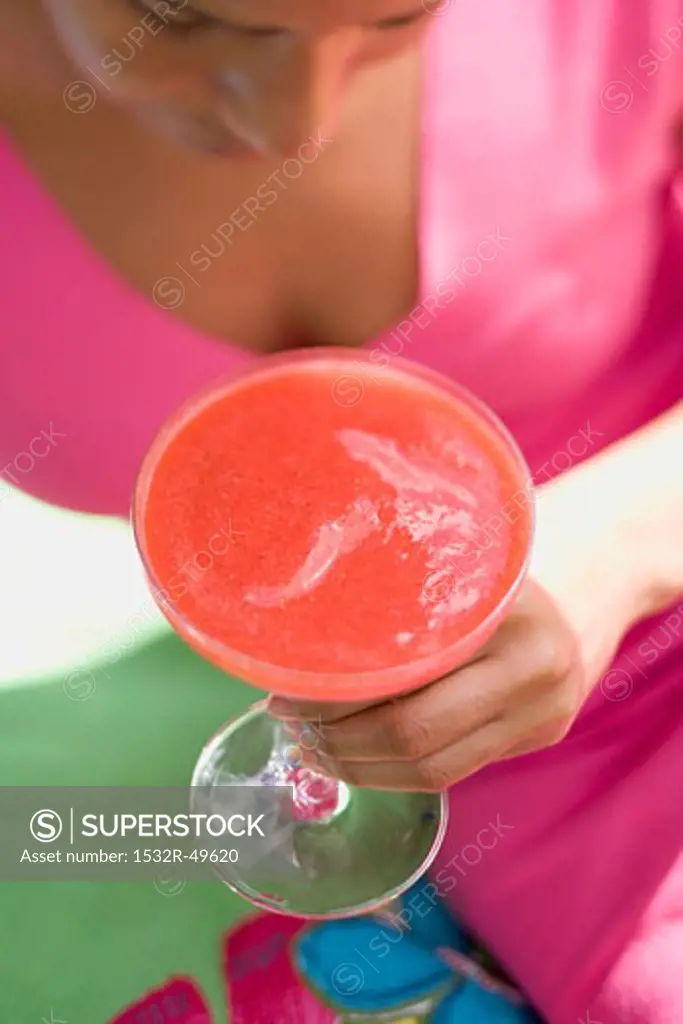 Woman holding fruity strawberry drink