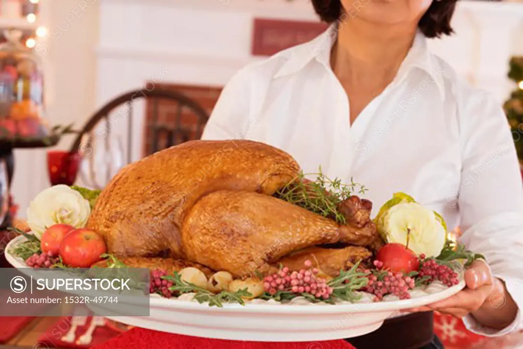 Woman serving roast turkey for Christmas