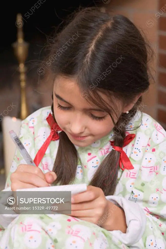 Girl writing her Christmas wish list