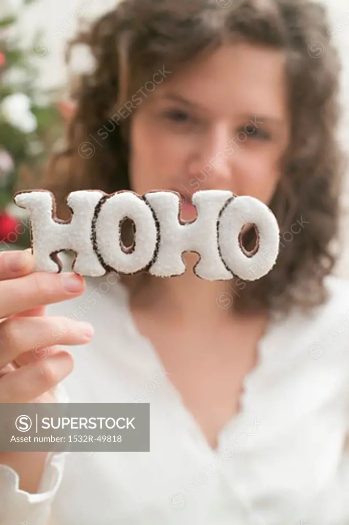 Woman holding biscuit (the word HOHO)