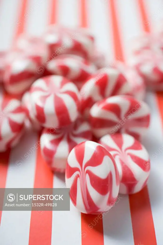 Several peppermints on striped background
