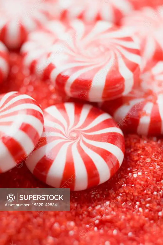 Peppermints on red sugar