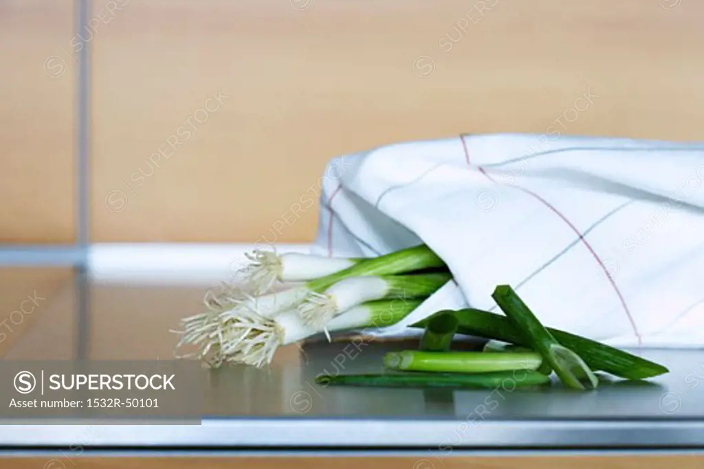 Spring onions wrapped in a tea towel