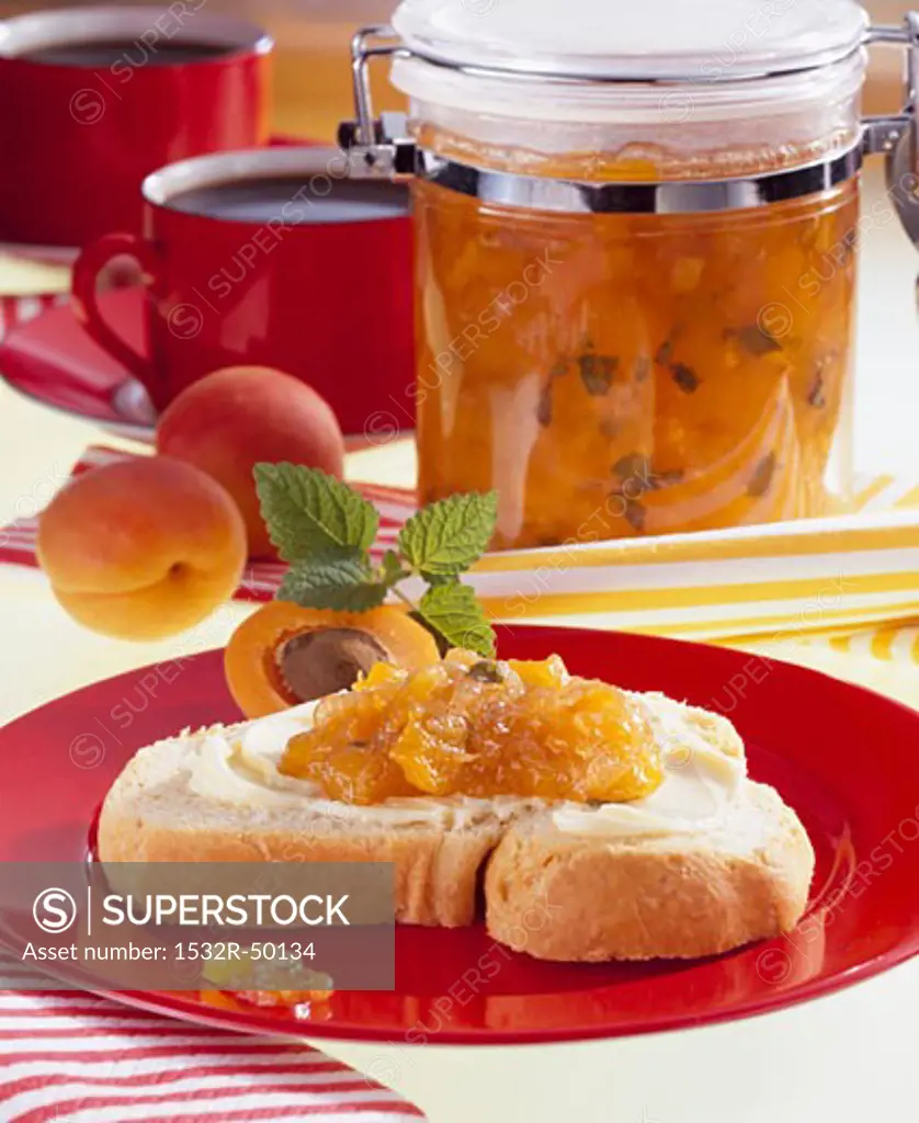 Apricot & nectarine jam in preserving jar & on slice of bread