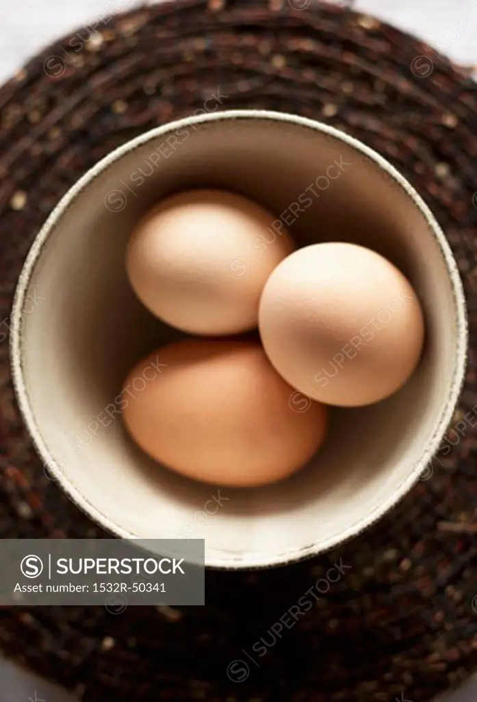 Three eggs in a bowl (overhead view)