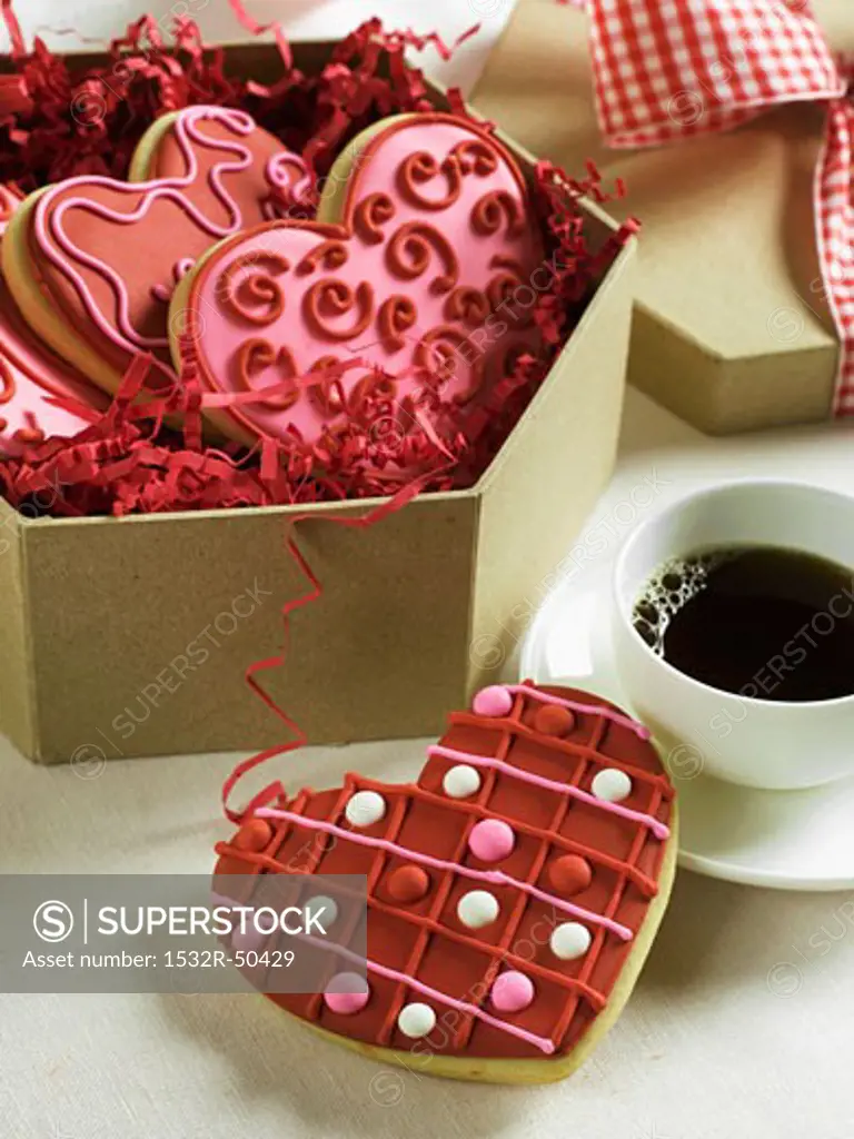 Box of Decorated Heart Cookies For Valentine's Day; One with Coffee