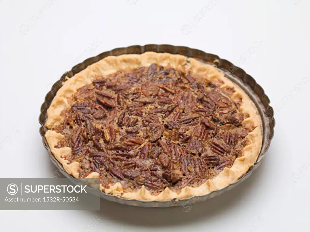 Whole pecan pie in the baking dish