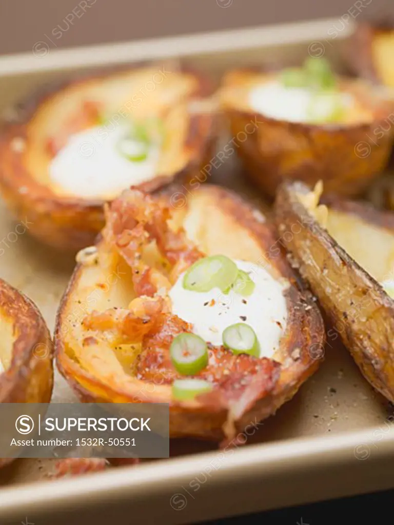 Baked potato skins with bacon, sour cream and chilli rings