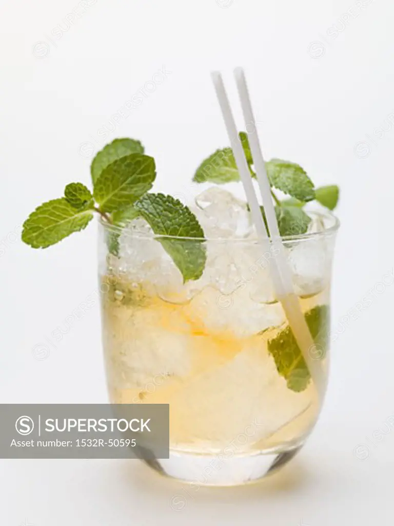 Mojito with mint, ice cubes and straws