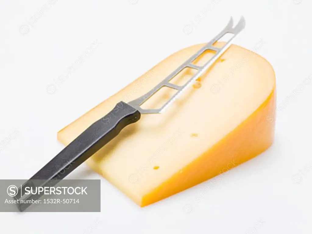 Piece of Gouda with cheese knife