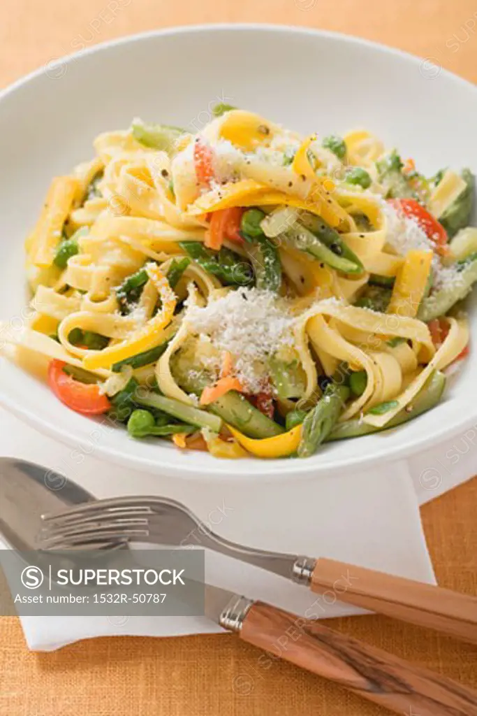 Tagliatelle primavera with vegetables and grated cheese