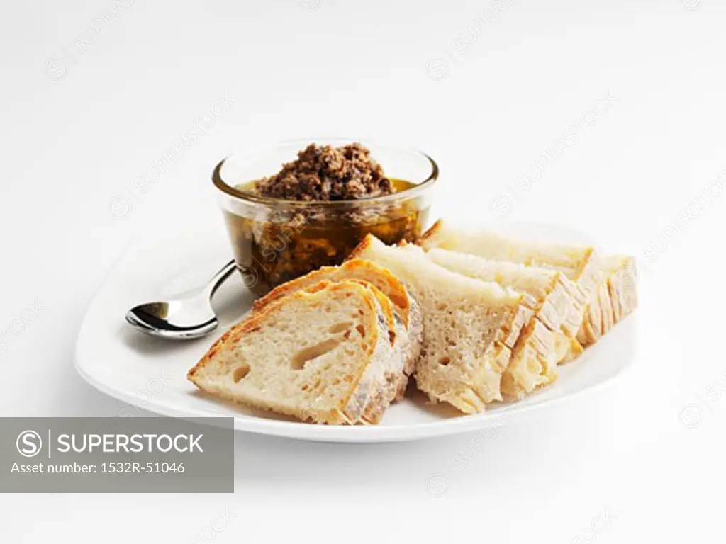 Tapenade and slices of bread on plate