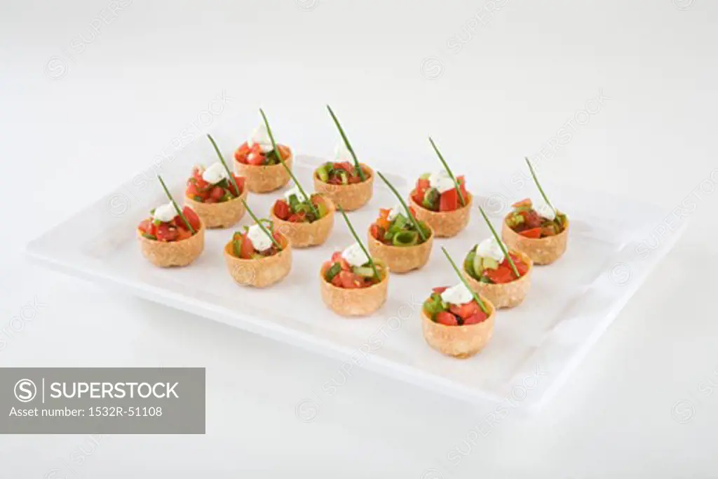 Croustades with spring onions, cherry tomatoes, garlic dip