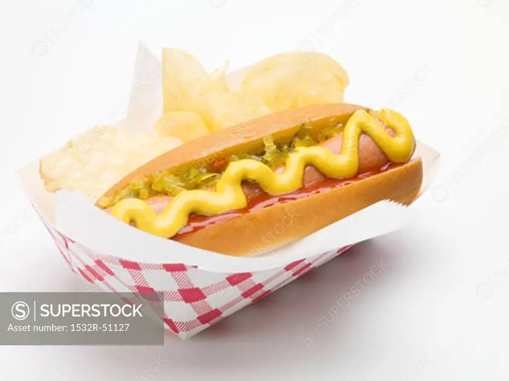 A hot dog with potato crisps