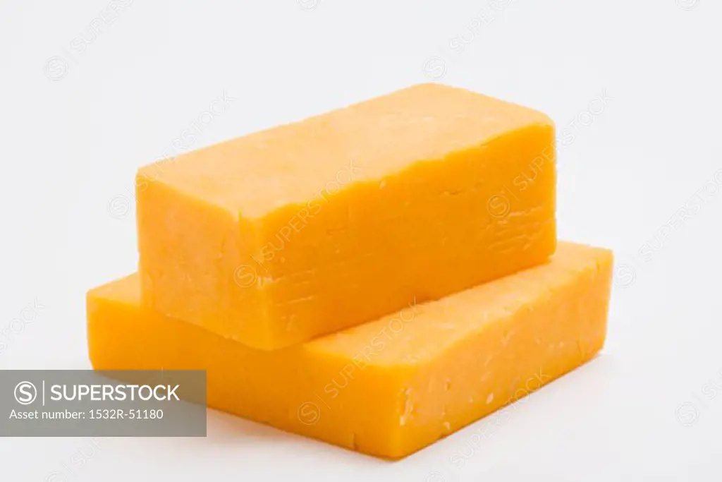 Two pieces of Cheddar cheese
