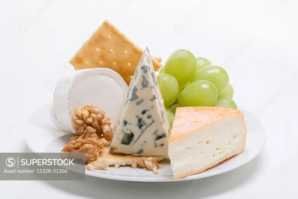 Cheese plate with crackers, nuts and grapes