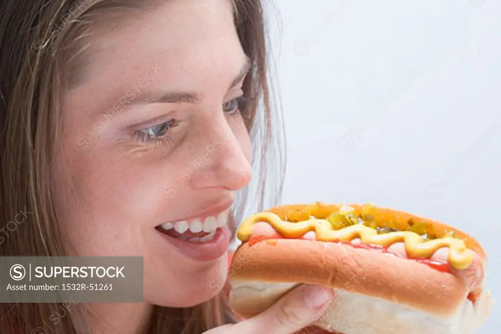 Young woman looking at a hot dog