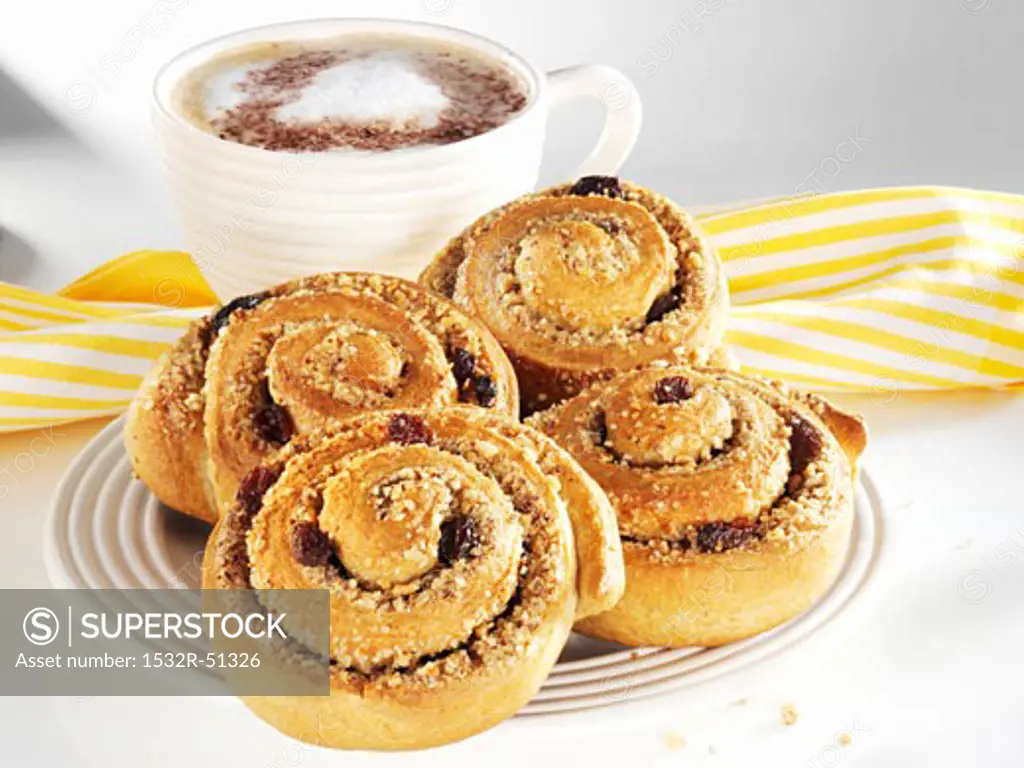 Wholemeal cinnamon buns with nuts and raisins, with coffee