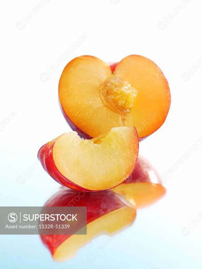 Half a plum and wedge of plum with reflection