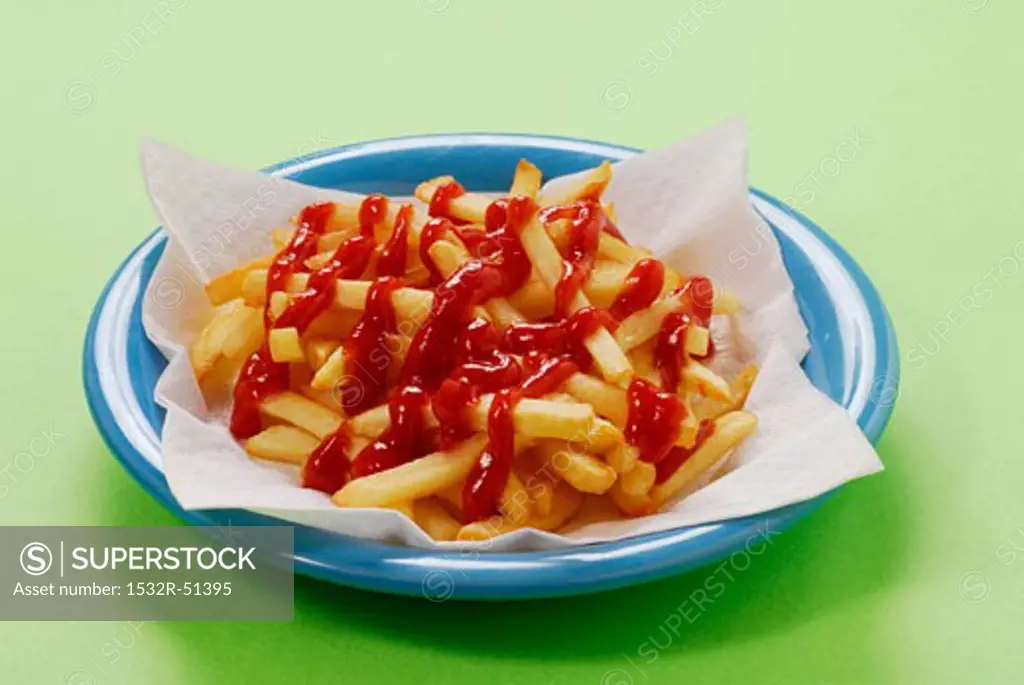 A plate of chips with a lot of ketchup