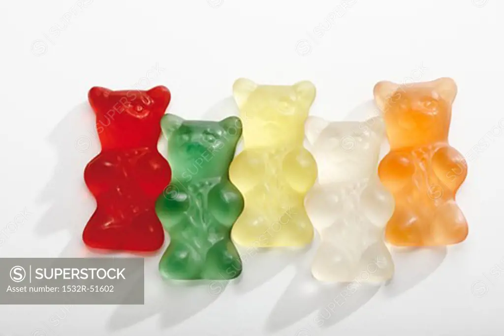 Five different coloured gummi bears in a row
