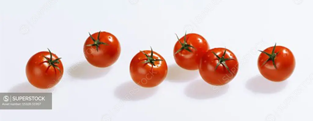 Several cherry tomatoes in a row