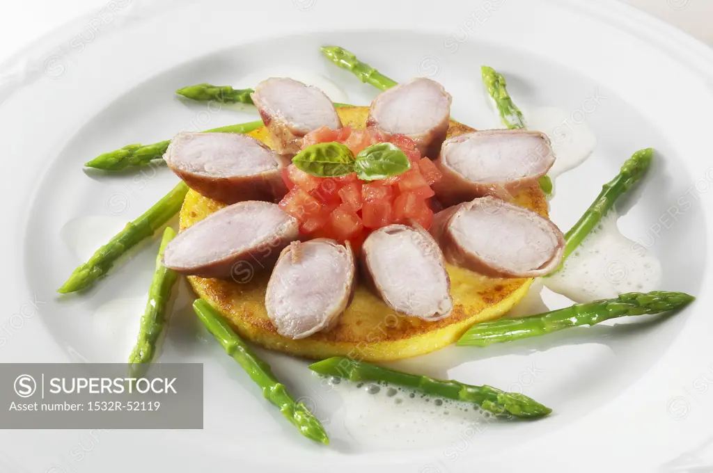 Rabbit loin & diced tomato on pancake, surrounded by asparagus