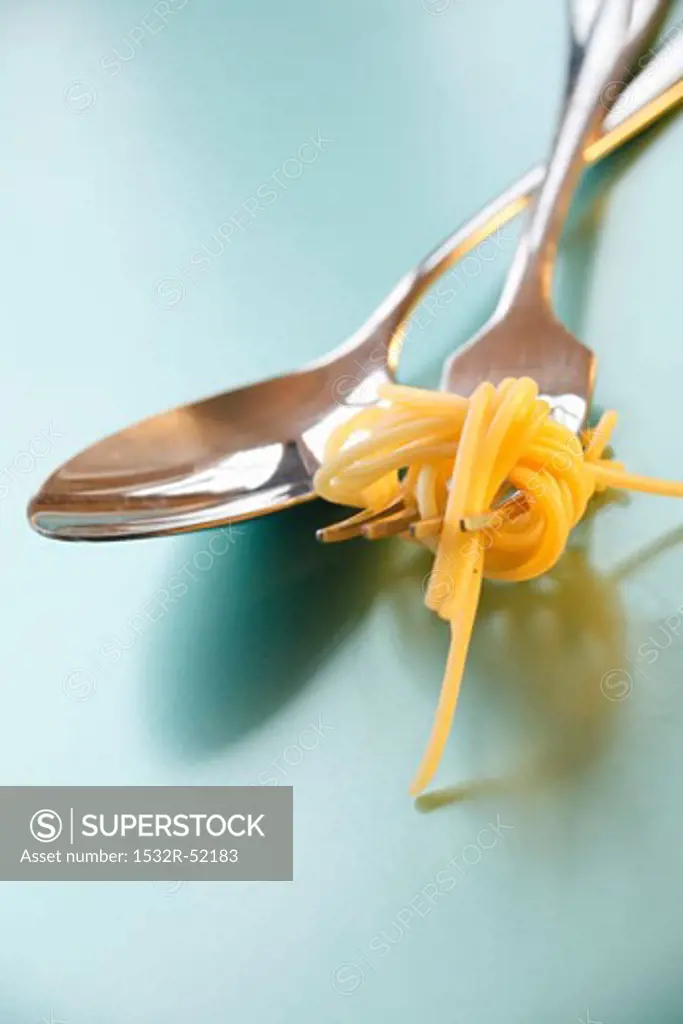 Spoon and fork with spaghetti