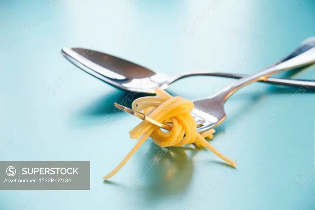 Spoon and fork with spaghetti