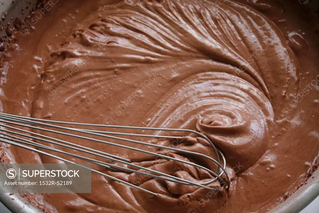 Mousse au chocolat in a mixing bowl with whisk