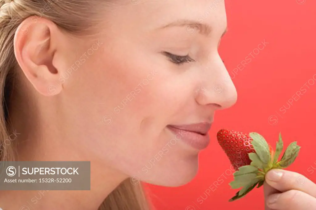 Woman holding a strawberry