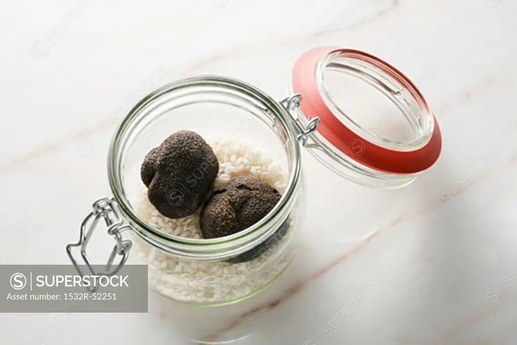 Black truffles and risotto rice in preserving jar