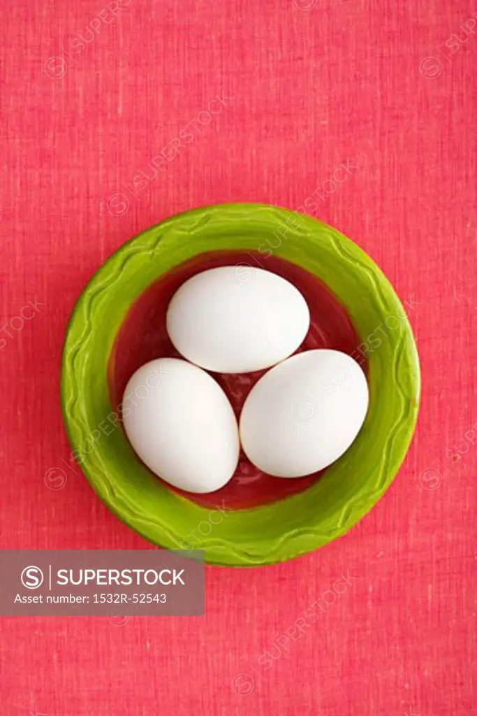 Three White Eggs in Green Bowl; From Above