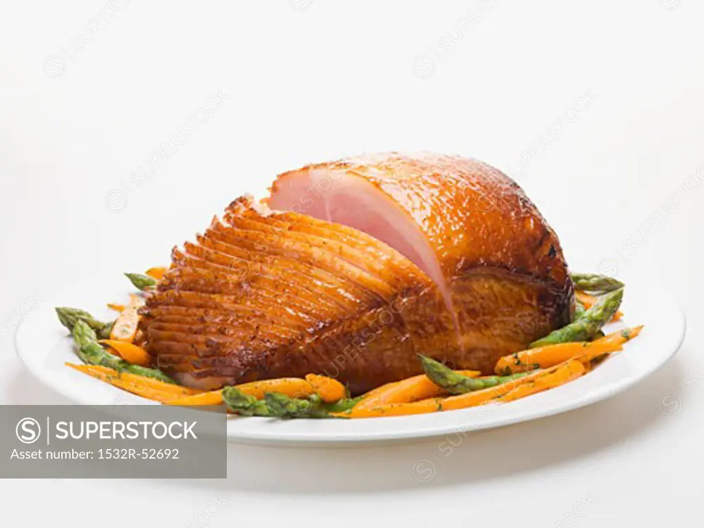 Glazed roast ham with carrots and asparagus