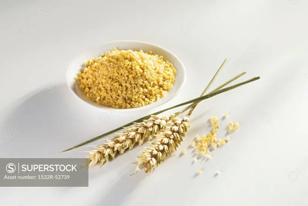 Bulgur in small dish, ears of wheat ears beside it