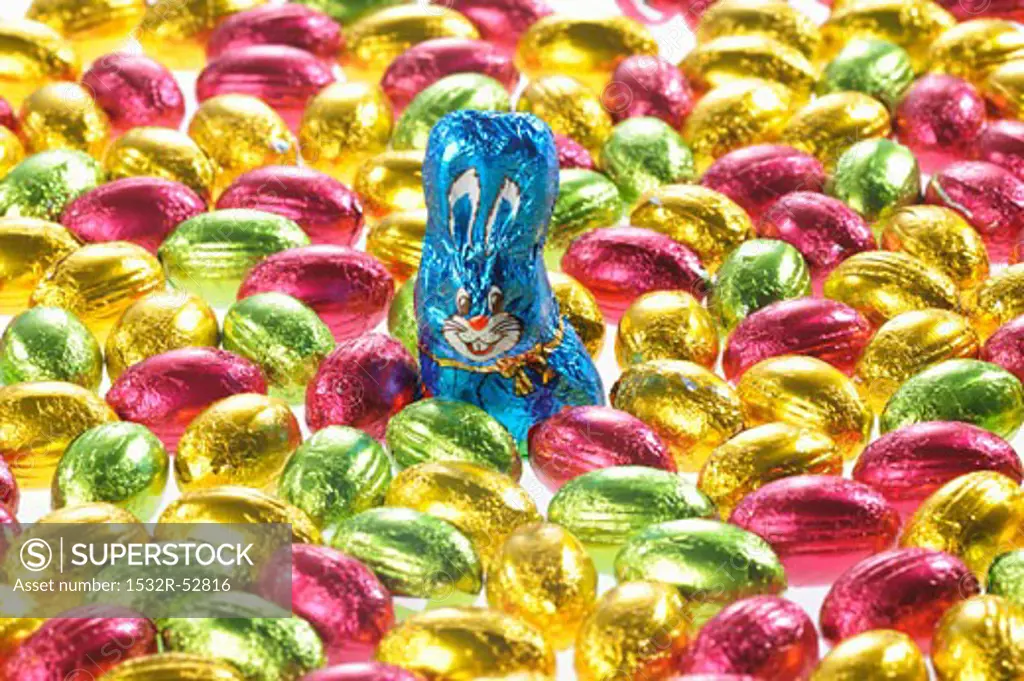 Small chocolate eggs in coloured foil, chocolate Easter Bunny