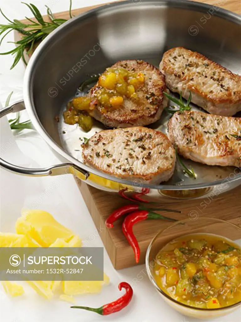 Pork steaks with relish in frying pan