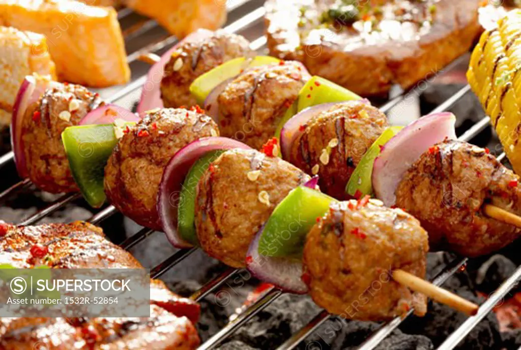 Meat, onion and pepper kebabs on barbecue
