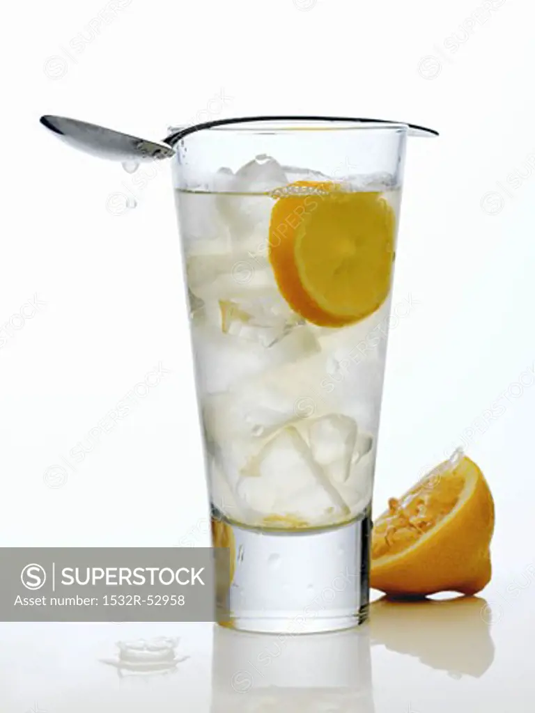 Glass of Lemonade with Lemon and Spoon