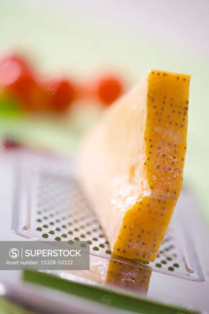 A piece of Parmesan on a grater