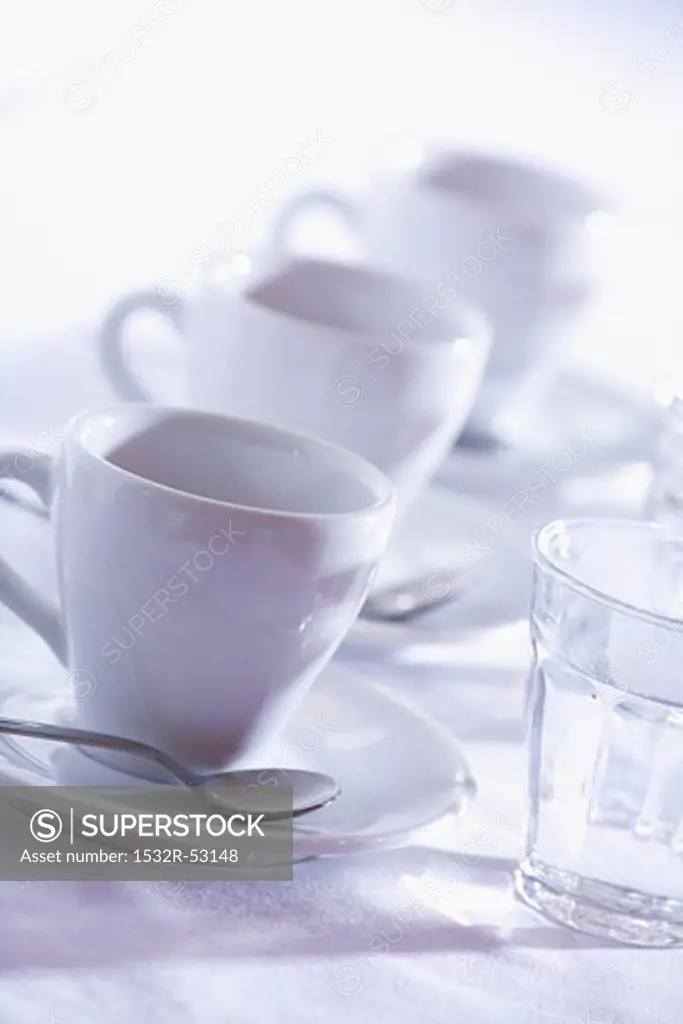 Three cups of espresso with glasses of water