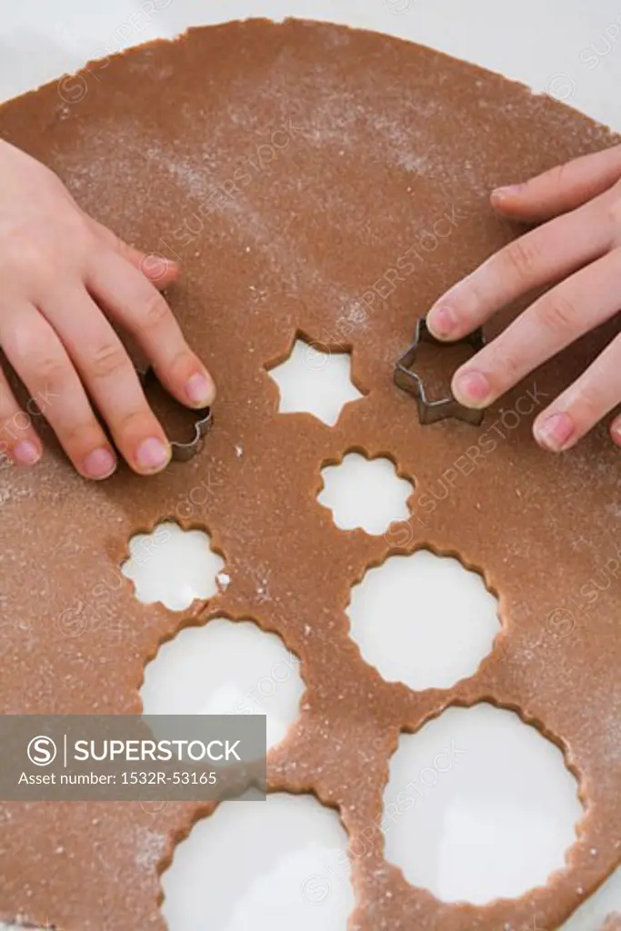 Children cutting out Christmas biscuits