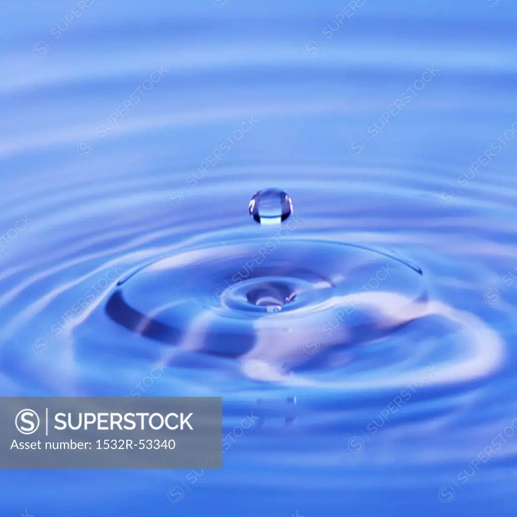 Drop of water falling into water