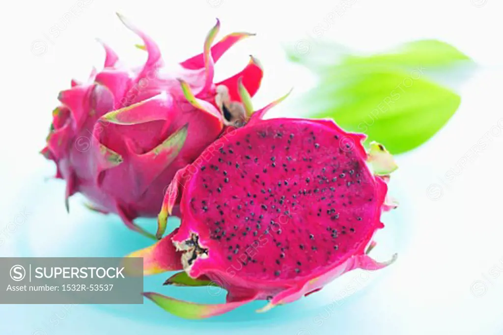 Pink-fleshed dragon fruit, whole fruit and a half